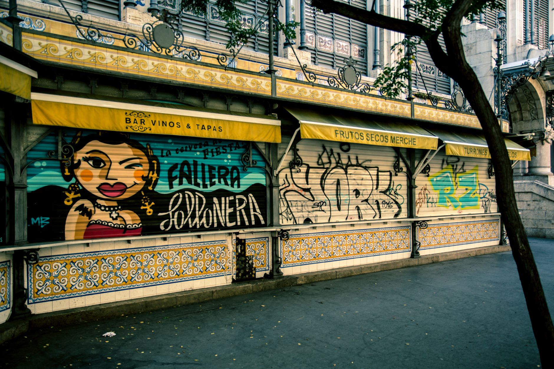 Vibrant street art decorates a building facade in Madrid, Spain, showcasing urban culture.